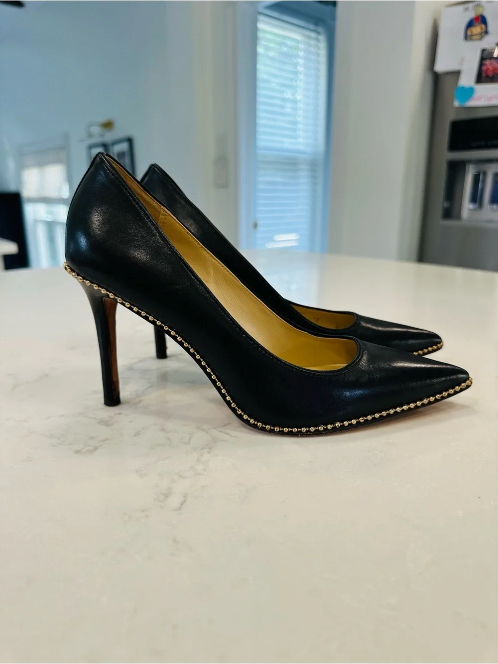 Coach Tamera Black Leather Pointed Toe Pumps with Gold Beaded Accent
